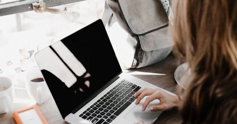 Creative Entrepreneurs - Close-up Photography of Woman Sitting Beside Table While Using Macbook