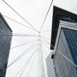 Mergers - a view of two tall buildings from the ground