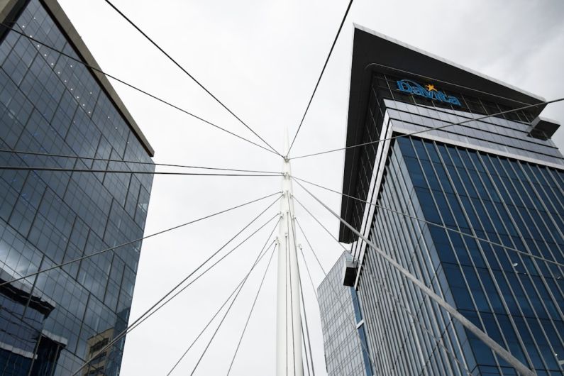 Mergers - a view of two tall buildings from the ground