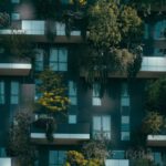 Community Development - Modern residential building facade decorated with green plants