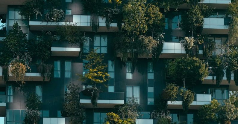 Community Development - Modern residential building facade decorated with green plants