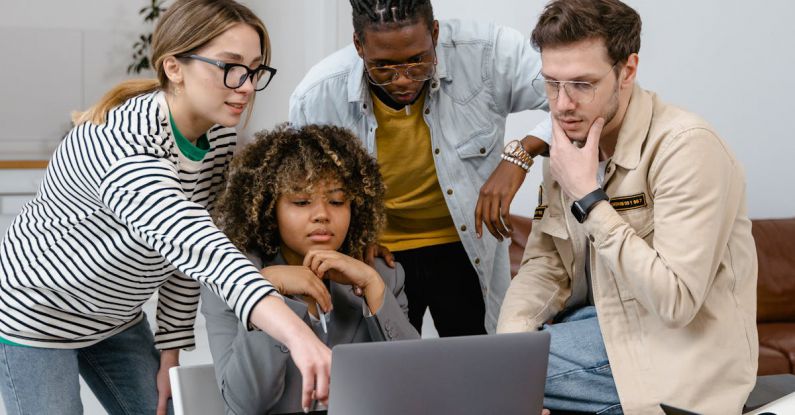 Entrepreneurs - A Group of People Planning while Looking at the Laptop