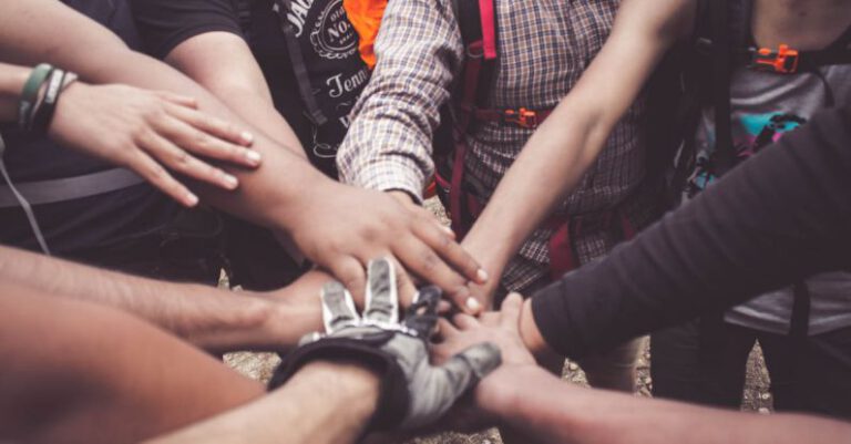Collaborative Communities - People Doing Group Hand Cheer