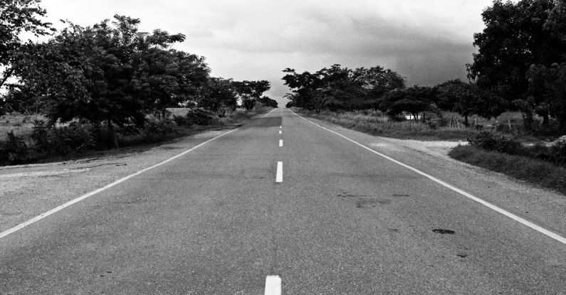 Uncertainty - Grayscale Photography of Concrete Road during Daytime