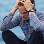 Failure - Man in Blue and Brown Plaid Dress Shirt Touching His Hair