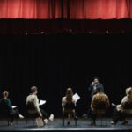 Performance Reviews - Group of People Sitting on Chair on Stage