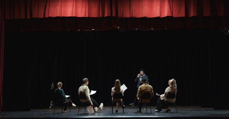 Performance Reviews - Group of People Sitting on Chair on Stage