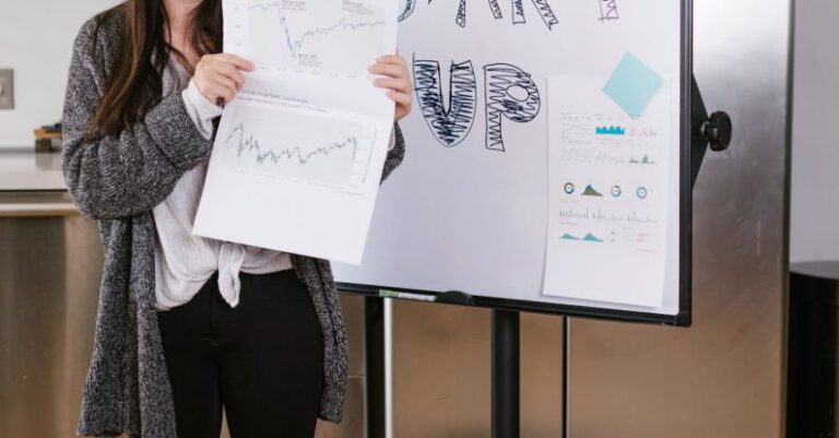 Socially Responsible Investments - Woman in Gray Coat Holding White Printer Paper