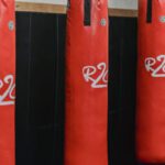 Supply Chains - Interior of boxing gym with heavy punching bags hanging on chains for workout