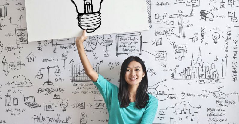 Business Idea - Woman Draw a Light bulb in White Board