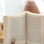 Wellness Programs - Woman reading book in bathtub during spa procedures