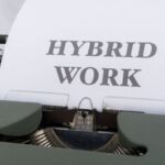 Workforces - A typewriter with the words hybrid work on it