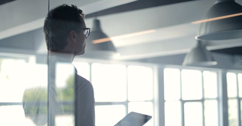 Creative Leader - Formal man with tablet giving presentation in office